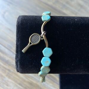Turquoise and brass stretch bracelet with tennis racket charm